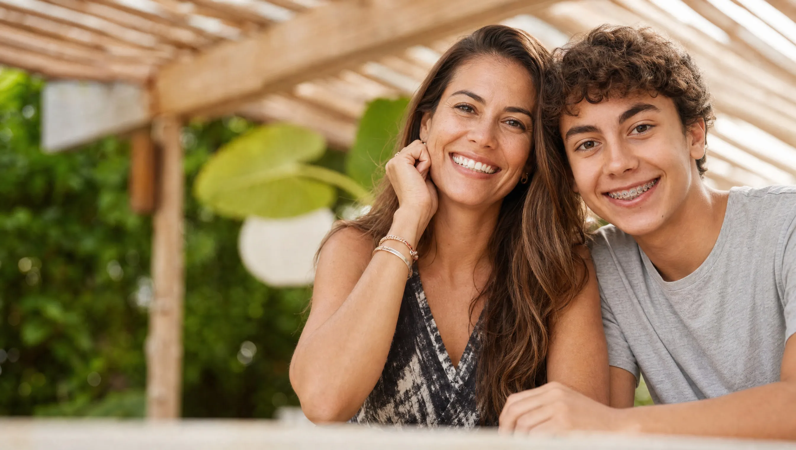 A mother and son smiling with confidence